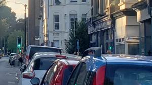 street with cars and train on viaduct